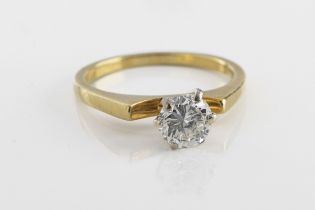 A yellow metal and diamond solitaire ring