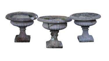 Three composite stone urns