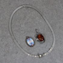 A silver flat woven necklace set with applied bow and pendant pearl