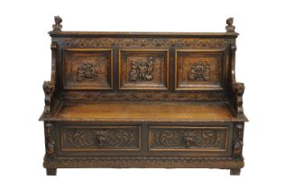 A Victorian carved oak settle