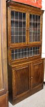 An early 20th century part glazed cupboard bookcase