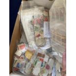 Shoebox crammed with used stamps sorted in bags (1000's)