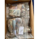 Box crammed with used stamps sorted in bags (1000's)