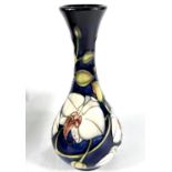 A modern Moorcroft baluster vase with long flared neck, decorated with 'Chatsworth Orchid',