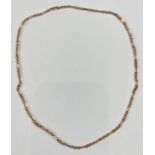 A yellow metal chain formed from alternating triple and elongated links, st. 375, 11.4gm
