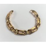 A yellow metal bracelet formed from elongated and circular links, stamped '18K', 23gm