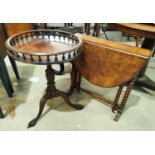 A reproduction mahogany wine table with circular galleried top, on turned and carved column and