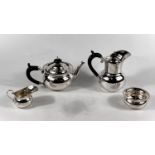 A hallmarked silver bachelors four piece tea-set with circular forn with beaded borders,