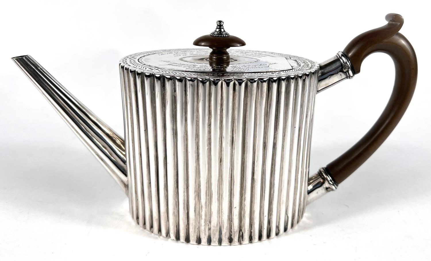 A Georgian hallmarked silver tea pot of oval ribbed form with inscriptions, London 1781, maker