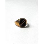 A 9ct gold gents signet ring set with a black stone, 3.2gms gross