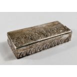 A hallmarked silver rectangular box with embossed decoration of classical figures in procession,