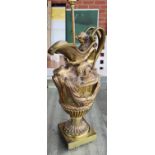 A brass jug lamp with ocean decoration in the form of Poseidon, with fish spout