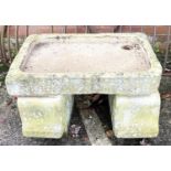An old stone sink on end supports