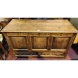 A late 18th/ early 19th century country made oak mule chest with hinged plank top, carved frieze,