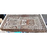 A brown and cream ground middle eastern rug decorated with buildings etc, possibly cut down