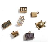 Seven various 9 carat hallmarked gold charms including £5, £10, £20 notes, folded, gross 24gm