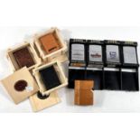 Eight various Zippo lighters:  3 leather in wooden case; 1 wooden; Daytona 500; RMS Queen Elizabeth;