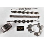 4 silver bracelets, a silver bangle, a silver charm bracelet with various charms and coins; a