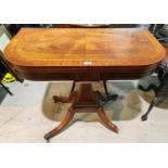 A reproduction Regency crossbanded mahogany tea table with fold-over top, on square tapering