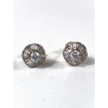 A pair of diamond earrings with central diamond, diameter approx. 5mm, surrounded by a wavy band of