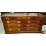 A reproduction yew wood sideboard in the form of a military chest, fitted 9 drawers and inset