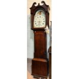 An early 19th century oak longcase clock with swan neck pediment and reeded side columns to the