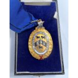 A yellow metal oval mayoral medallion with enamelled coat of arms, inscribed, stamped '9ct', in