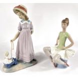 Two Lladro figures:  girl with pull-along doll, No 5044, height 28cm; a seated ballerina B-18D