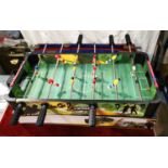 A table football table boxed with balls etc