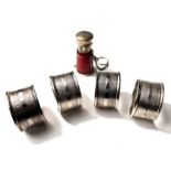 A hallmarked silver set of engine turned napkin rings, Birmingham 1945, 2oz; a silver mounted whisky