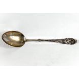 A very large Danish white metal basting spoon, with naturalistic decoration to finial end,