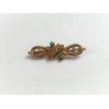 An Edwardian bar brooch in the form of a knot set with 2 seed pearls and turquoise, mark unclear,