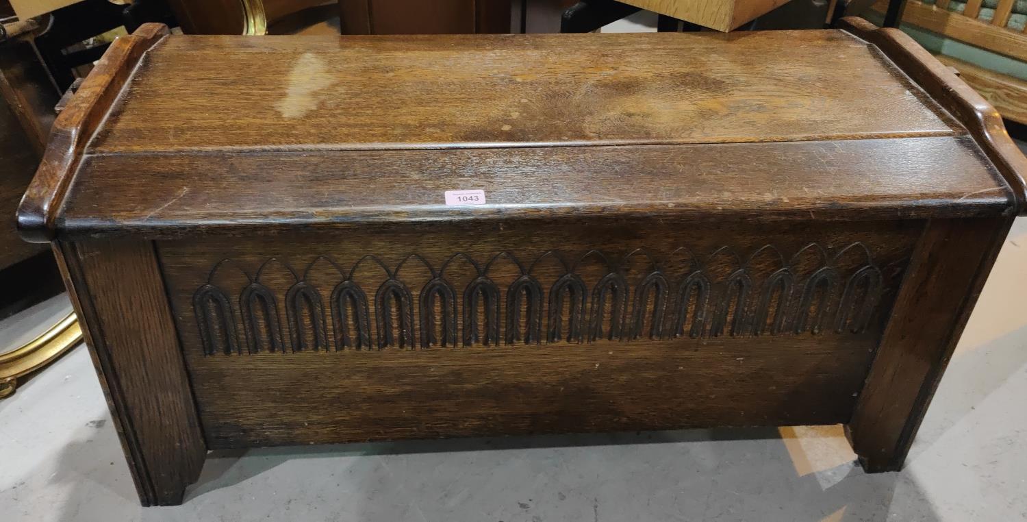 A carved oak plank style bedding chest with hinged lid