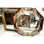 An octagonal wall mirror in antique effect mirrored frame; a rectangular wall mirror in floral frame