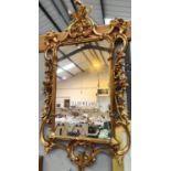 A Georgian style wall mirror in ornate gilt frame