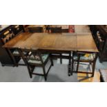 An Ecrol draw leaf refectory dining table and four chairs matching Ercol chairs (2+2)