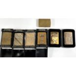 Seven brass or gilt covered cased Zippo lighters - 1 plain, two with incised floral decoration,