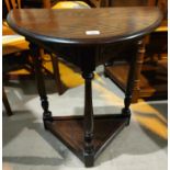 An oak demilune side table with shelf under