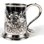 A Georgian hallmarked silver tapering cylindrical 1 pint mug with extensive scroll embossed