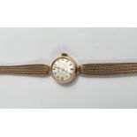 A lady's Roamer wristwatch in 9 carat hallmarked gold, on woven 9 carat strap, 15gm gross weight