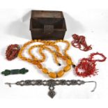 A bakelite amber bead necklace; 2 coral necklaces; etc.