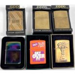 Six various Zippo lighters:  2 plain brass; a brass campaign lighter; a monogrammed lighter; a