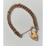 A 9 carat hallmarked gold curb link bracelet with 9 carat hallmarked gold heart lock, 30gm
