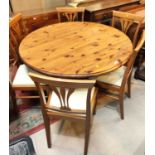 A modern circular pedestal pine dining table and 6 chairs