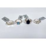 4 sterling silver dress rings including:- a Swiss blue topaz and white zircon; a pear shaped