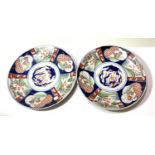 A pair of Imari circular wall plaques with scalloped borders, diameter 31cm