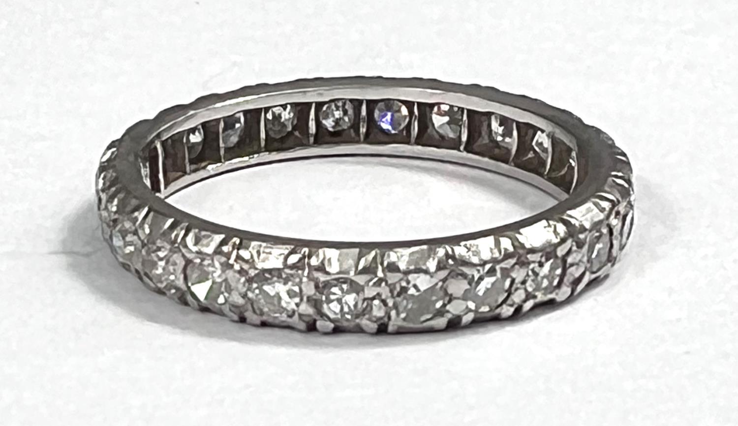 A white metal eternity ring with diamonds in illusion settings, size L, gross 3.3gm