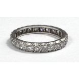 A white metal eternity ring with diamonds in illusion settings, size L, gross 3.3gm
