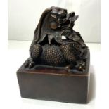 A large Chinese bronze seal with dragon sat on top and seal mark to base, ht 16cm