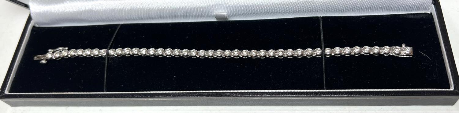 A 9 carat white gold ‘Tennis Bracelet’ set 42 diamonds (approximately 2 - 3 carats, each